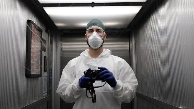 A member of hospital staff with a camera