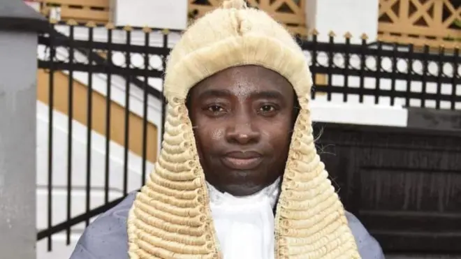 Justice Momoh-Jah Stevens looking straight wit im judge wig