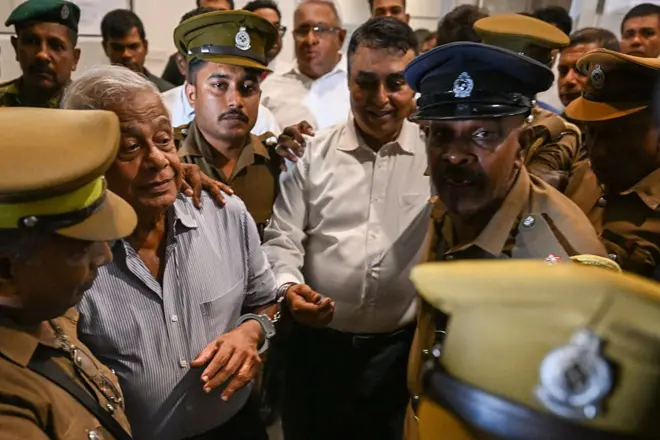Former police chief Pujith Jayasundara (R) and former defence ministry secretary Hemasiri Fernando (L) are taken to prison after receiving death sentence, in Colombo on July 31, 2026. A Sri Lanka court sentenced two ex-security officials to death on July 31 for failing to prevent the 2019 Easter Sunday bombings, which killed 279 people including 45 foreigners. 
