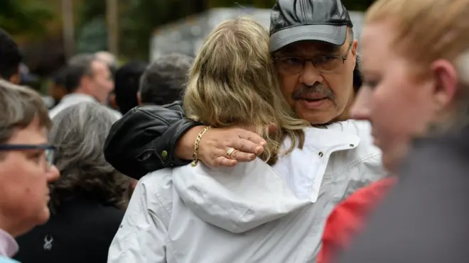 People comfort each other at the site of a mass shooting at the Tree of Life Synagogue in the Squirrel Hill neighborhood on October 27, 2018 in Pittsburgh, Pennsylvania