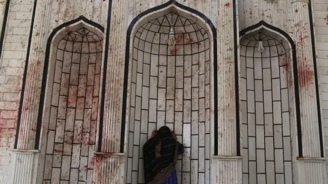 Woman at bloodstained wall