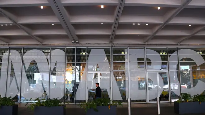 An employee walks past the ABC logo at the main entrance to the ABC building located at Ultimo in Sydney, New South Wales, Australia, 05 June 2019