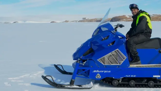 Dr Tomar riding a snow scooter.