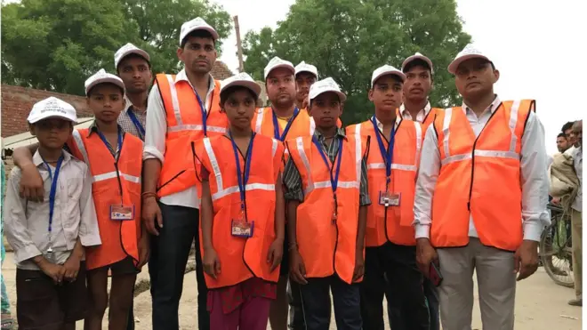 A group of volunteers who are out at sunrise to stop people going to the toilet in the fields