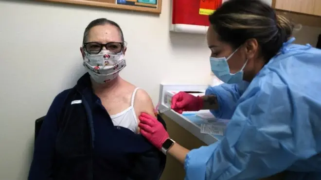 Francisca Bojorquez receives a Covid-19 vaccine at East Valley Community Health Center in La Puente, California, 5 March 2021.
