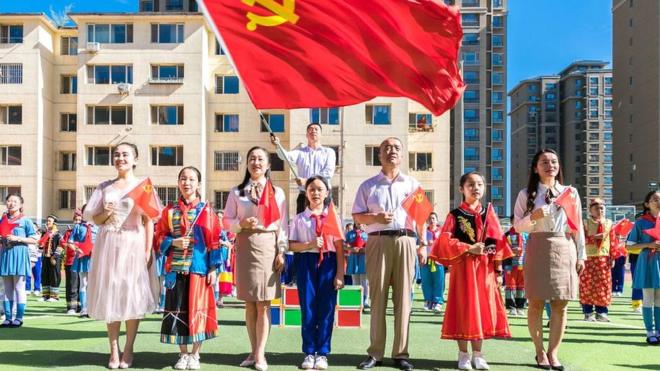Primary school teachers and students sing during a theme event celebrating the 100th anniversary of the founding of the Communist Party of China (CPC) in Hohhot, Inner Mongolia, China, on 30 June 2021