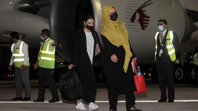 Travellers from Kabul disembark their plane in Doha, 9 September 2021