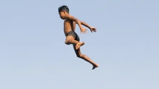 On Saturday, children cool off in the outskirts of Cairo...