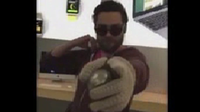 An unnamed man was captured on camera using a solid metal ball to crush several smartphones