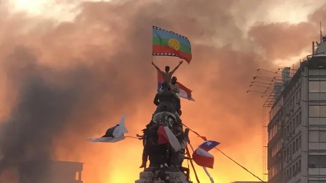 Imagembetsul pagamanifestante com bandeira Mapuche no topobetsul pagaestátua militarbetsul pagaSantiago se tornou símbolo dos protestos no Chile por reformas sociais