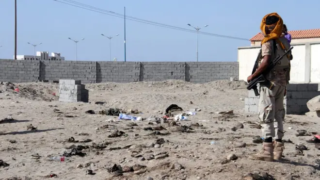A soldier stands at the site of the blast