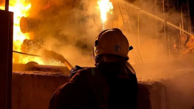 A firefighter works to extinguish a fire at a power infrastructure object on 6 December