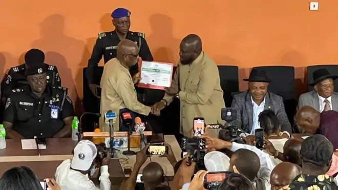 Dr Odey dey present certificate of return to Bariere Thomas, Cahormen elect Khnana LGA with cameramen with dem