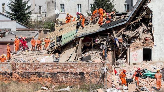 Polish emergency staff and firefighters work at the scene of a gas explosion that caused a tenement building to collapse in Swiebodzice, southwestern Poland, 08 April 2017