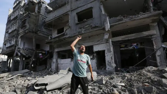 A resident shouts around destroyed buildings and debris at the Al-Karama neighborhood after an Israeli airstrike that has been going on for five days in Gaza City, Gaza on October 11, 2023