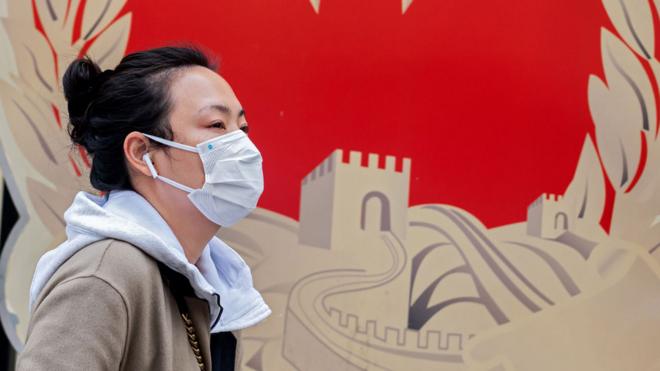 A woman wearing a facemask in Beijing, China