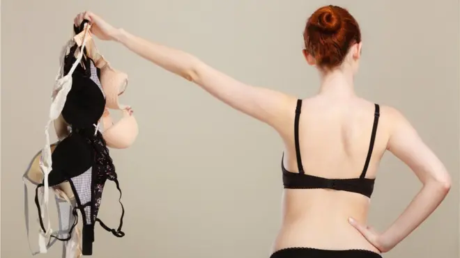 A woman holding bras