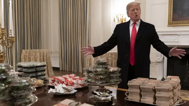 US President Donald Trump presents fast food to be served to the Clemson Tigers football team