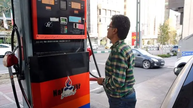 A man fills up his vehicle at a petrol station in Tehran on 15 November 2019