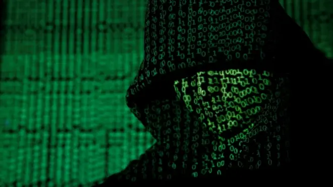 Projection of cyber code onto a hooded man