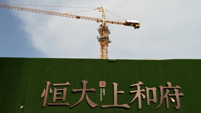 The Evergrande name and logo are seen outside the construction site of an Evergrande housing complex in Beijing on September 13, 2021