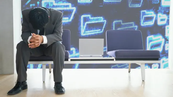 Man who's been hacked sitting with head hung