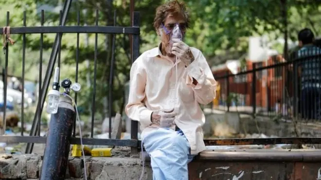 A patient, wearing an oxygen mask