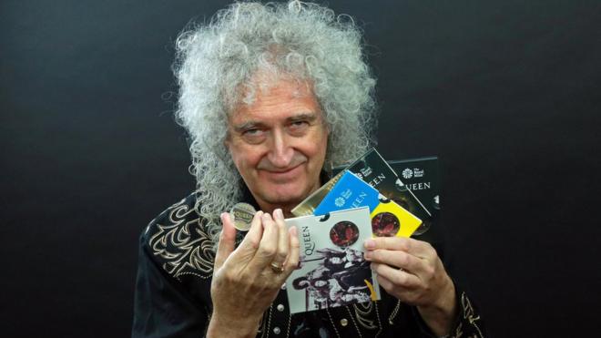 Guitarist Brian May of band Queen poses with a 5-pound in this undated picture obtained by Reuters on January 17, 2020.