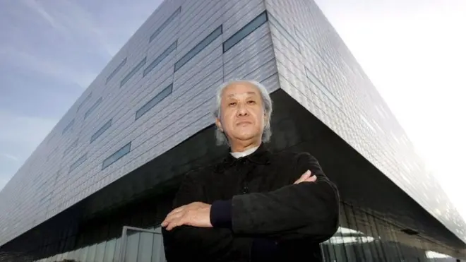 Arata Isozaki in front of the Palahockey palace he designed with another architect in Turin, Italy