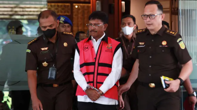 Menteri Komunikasi dan Informatika Johnny G Plate (tengah) berjalan menuju mobil tahanan usai menjalani pemeriksaan di Kejaksaan Agung (Kejagung) pada Rabu (17/5)