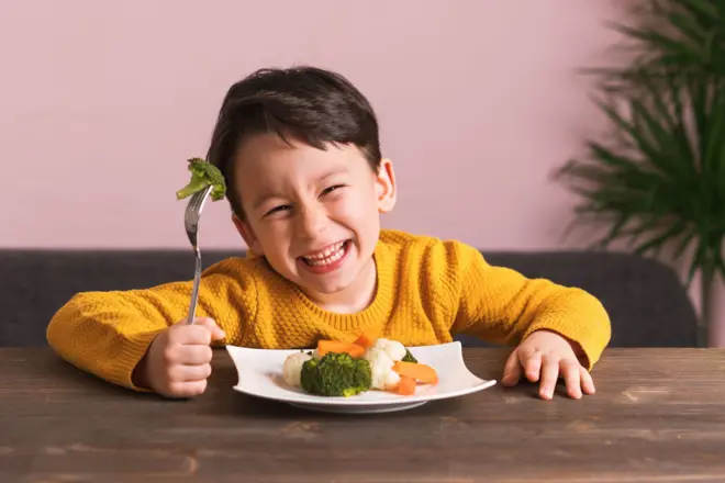 A little boy with vegetables 