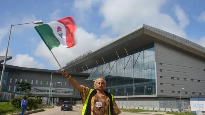 Female protester wey waive NLC flag