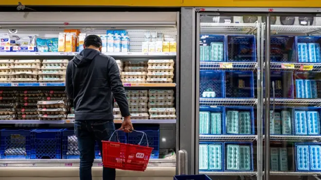 Man looking at eggs in US supermarket