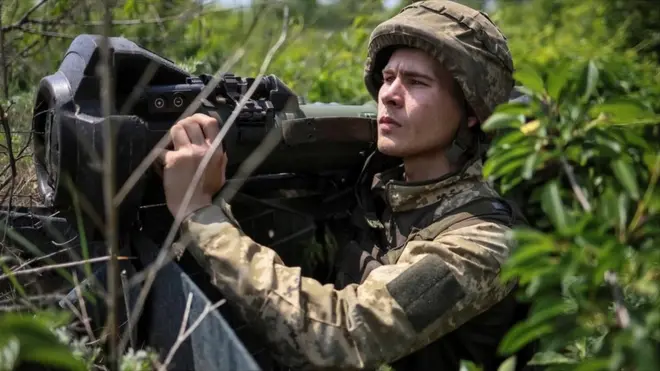 A Ukrainian service member holds a next generation light anti-tank weapon (NLAW)