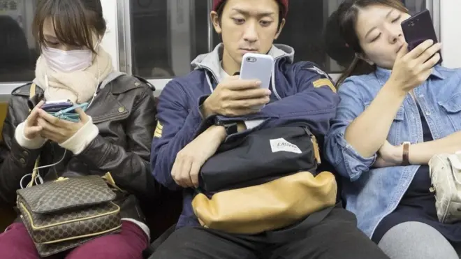 people looking at phones