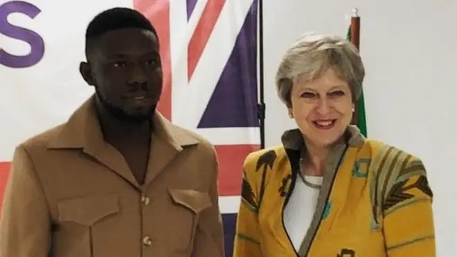 Emmanuel Okoro bụ onye kwara uweelu Theresa May yi oge ọ bịara Naijiria