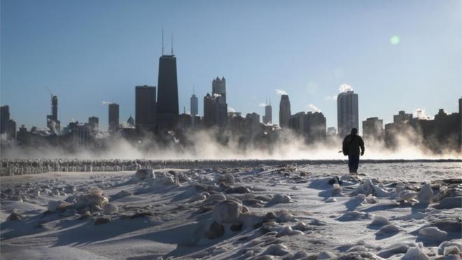 Man walks along frozen Chicago lakeside