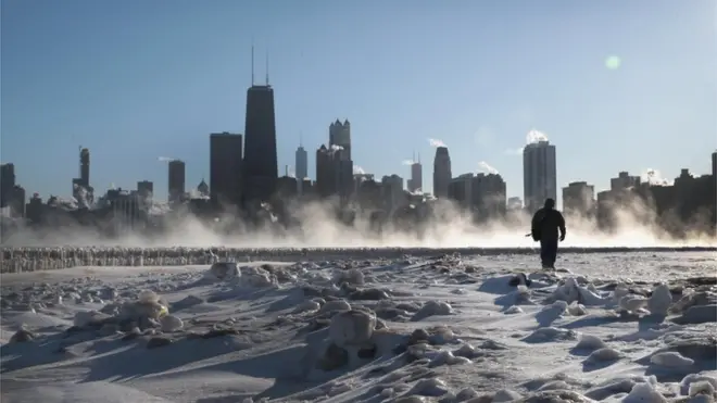 Man walks along frozen Chicago lakeside