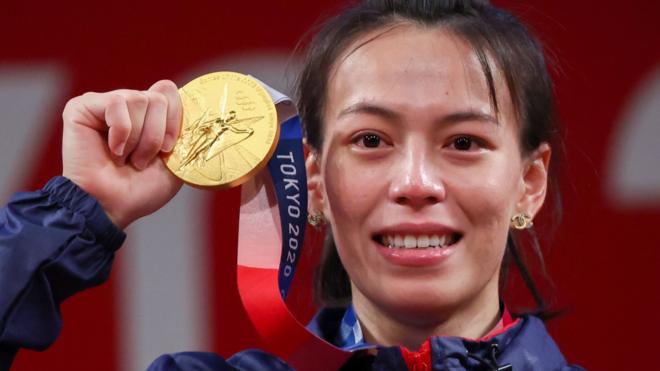 Tokyo 2020 Olympics - Weightlifting - Women"s 59kg - Medal Ceremony - Tokyo International Forum, Tokyo, Japan - July 27, 2021. Gold medalist Kuo Hsing-Chun of Taiwan reacts.