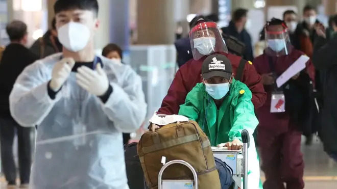 28일 인천공항에서 도착한 해외입국자들이 방역복을 입고 이동하고 있다