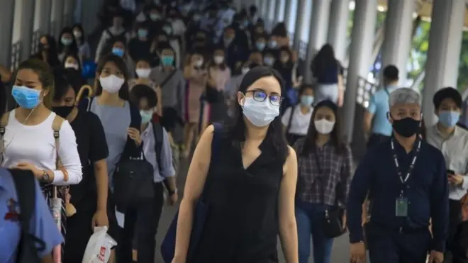 Commuters wearing protective masks walk through an overpass in Bangkok, Thailand, 01 September 2020
