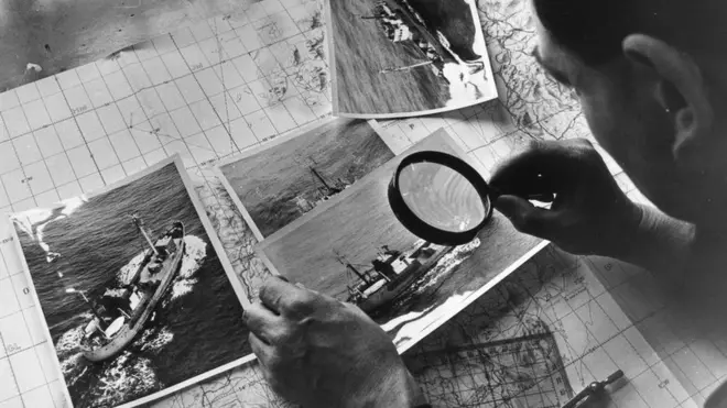 Изучение фотоснимков с увеличительным стеклом