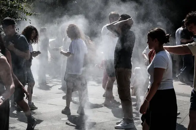 Pipo dey cool off wit misters inside one park for di Halles district of Paris on July 1, 2025, as heatwave hit France