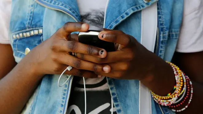 Woman wey dey look her phone