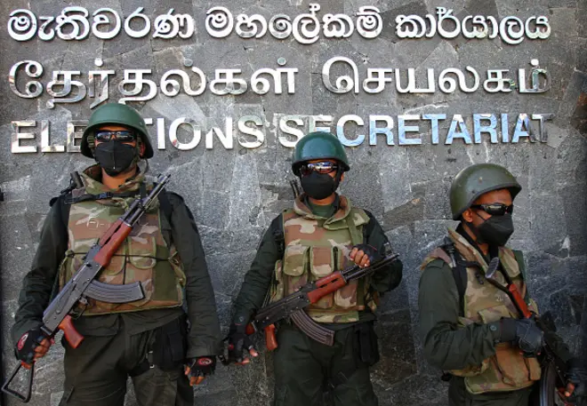 Army soldiers stand guard as anti-government protesters take part in a demonstration urging the government to hold the local council elections on the scheduled date in front of the Election Secretariat in Colombo on February 22, 2023