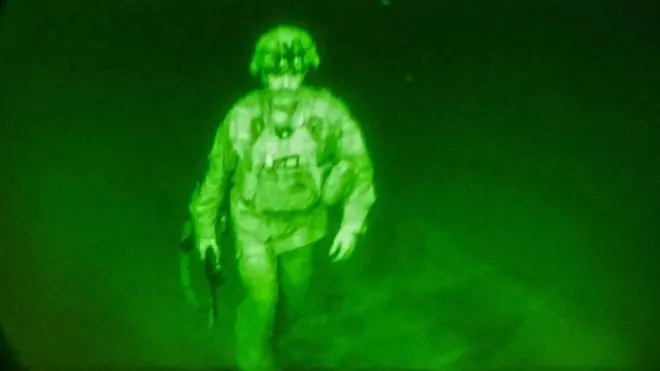 U.S. Army Major General Chris Donahue, commander of the 82nd Airborne Division, steps on board a C-17 transport plane
