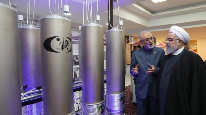 Iranian President Hassan Rouhani (2nd L) listening to head of Iran's nuclear technology organisation Ali Akbar Salehi (R) during the "nuclear technology day" in Tehran on 9 April.