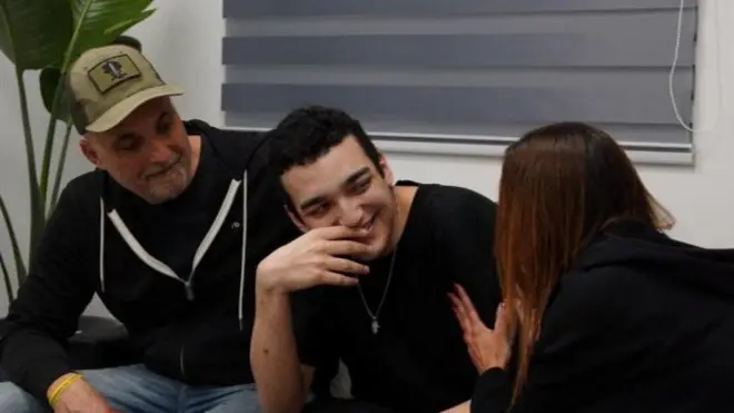 Edan Alexander, who was held hostage by Hamas, smiles after being reunited with his parents