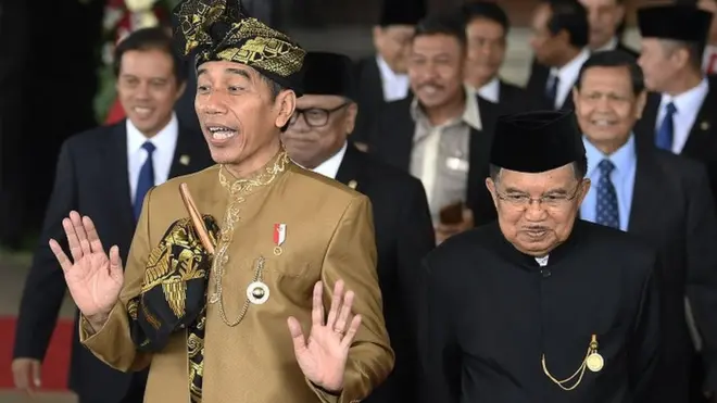Presiden Joko Widodo (kiri) bersama Wakil Presiden Jusuf Kalla (kanan) menyapa jurnalis usai Sidang Bersama DPD-DPR di Kompleks Parlemen, Senayan, Jakarta, Jumat (16/08).