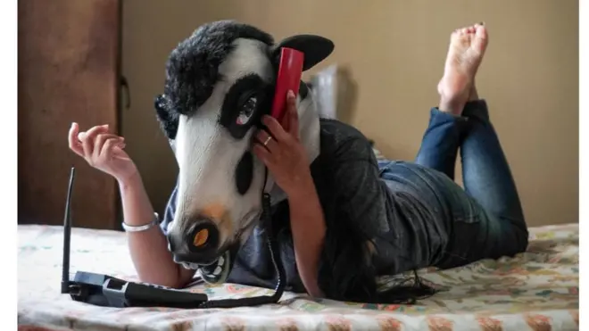 A woman with a cow mask